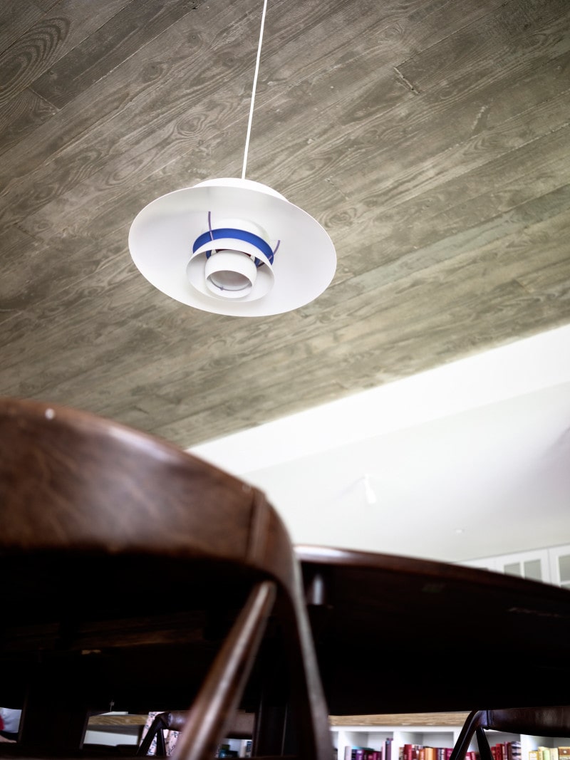 Luigi Rosselli, Louis Poulsen lights and exposed concrete ceiling dining room