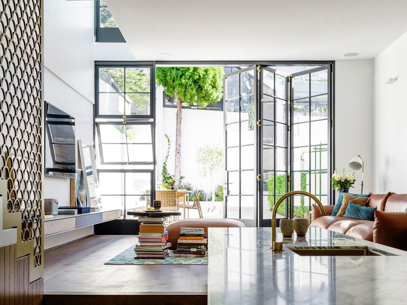 Luigi Rosselli Architects | Interiors timber bi-fold doors living room, Carrara marble kitchen top, brass screen