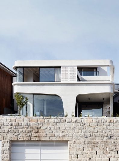 Luigi Rosselli designed Tamas Tee House Tamarama beach house with stone retaining wall, exposed off form concrete design, aluminium windows and custom concrete timber shutters