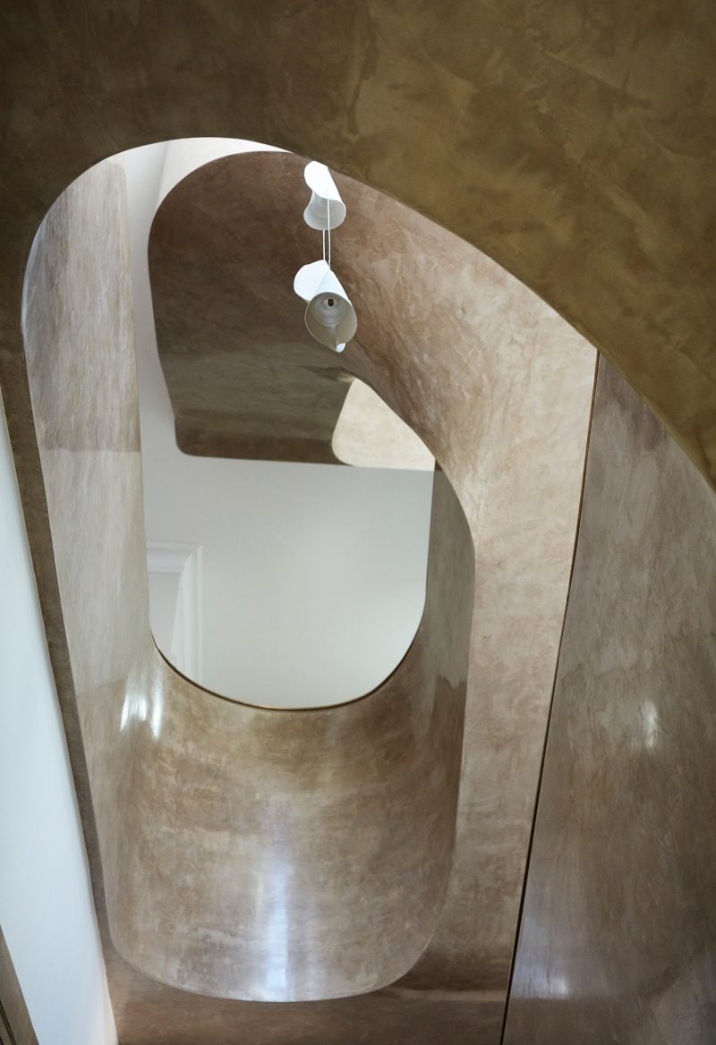 Luigi Rosselli Architects, sculptural stairs, suspended, sculptural ribbon stairs twisting stairs, pendant light, stuco paint