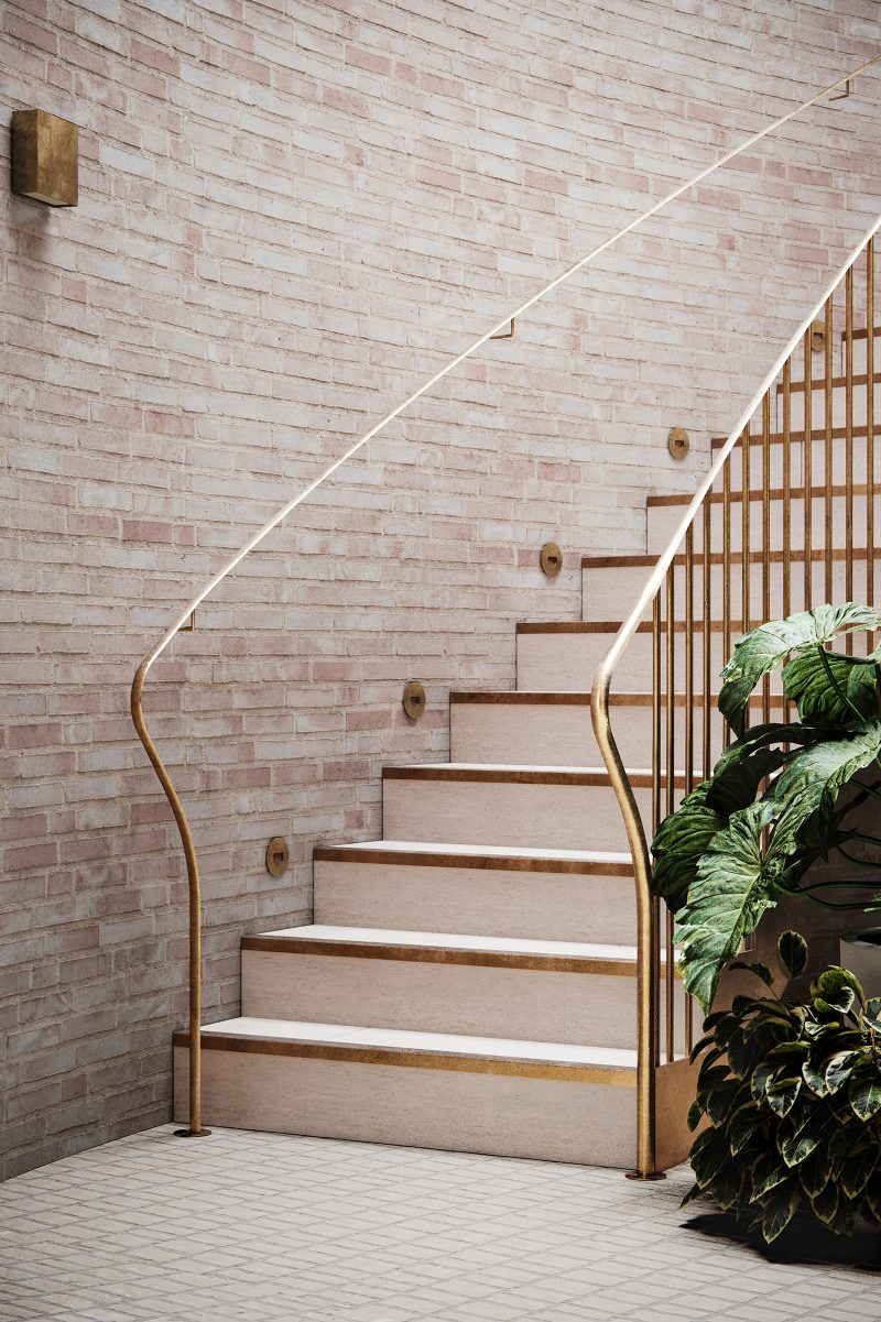 gold handrail on the central staircase, matching brass recessed wall lights fitted to lime-stained brick wall