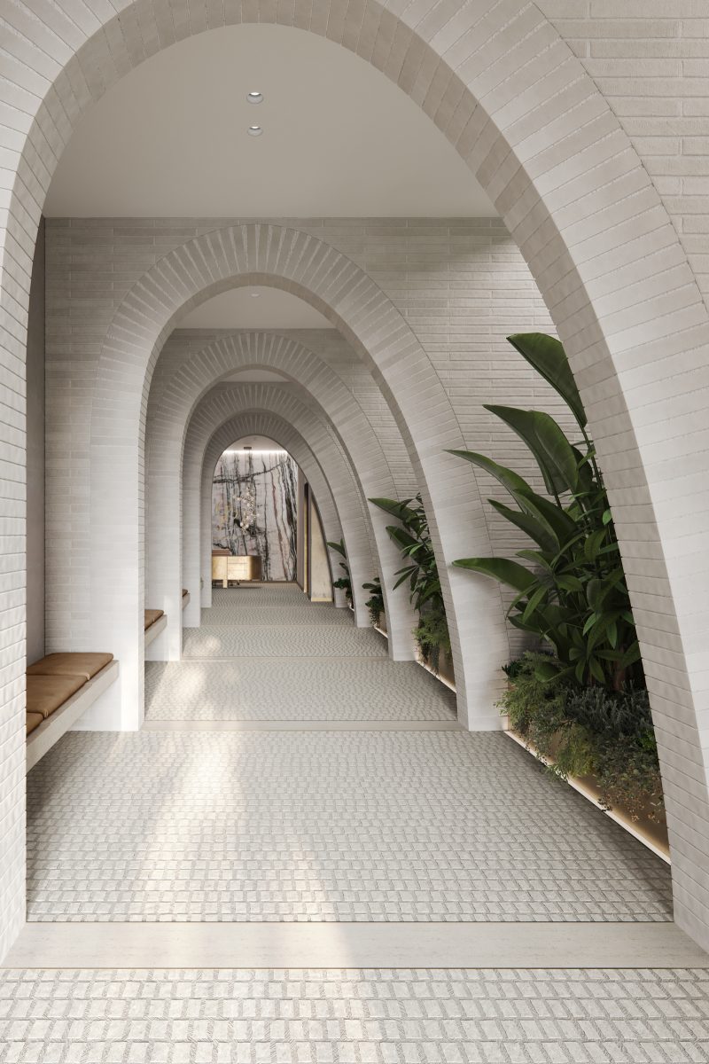Rows of white brick arches greets residents arriving into the private grand entrance. Tall planting between the arches separate the semi-public walkway from the public arcade