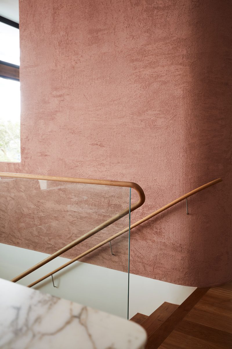 Luigi Rosselli Earth-ship, glass balustrade topped with a timber handrail, rammed earth wall