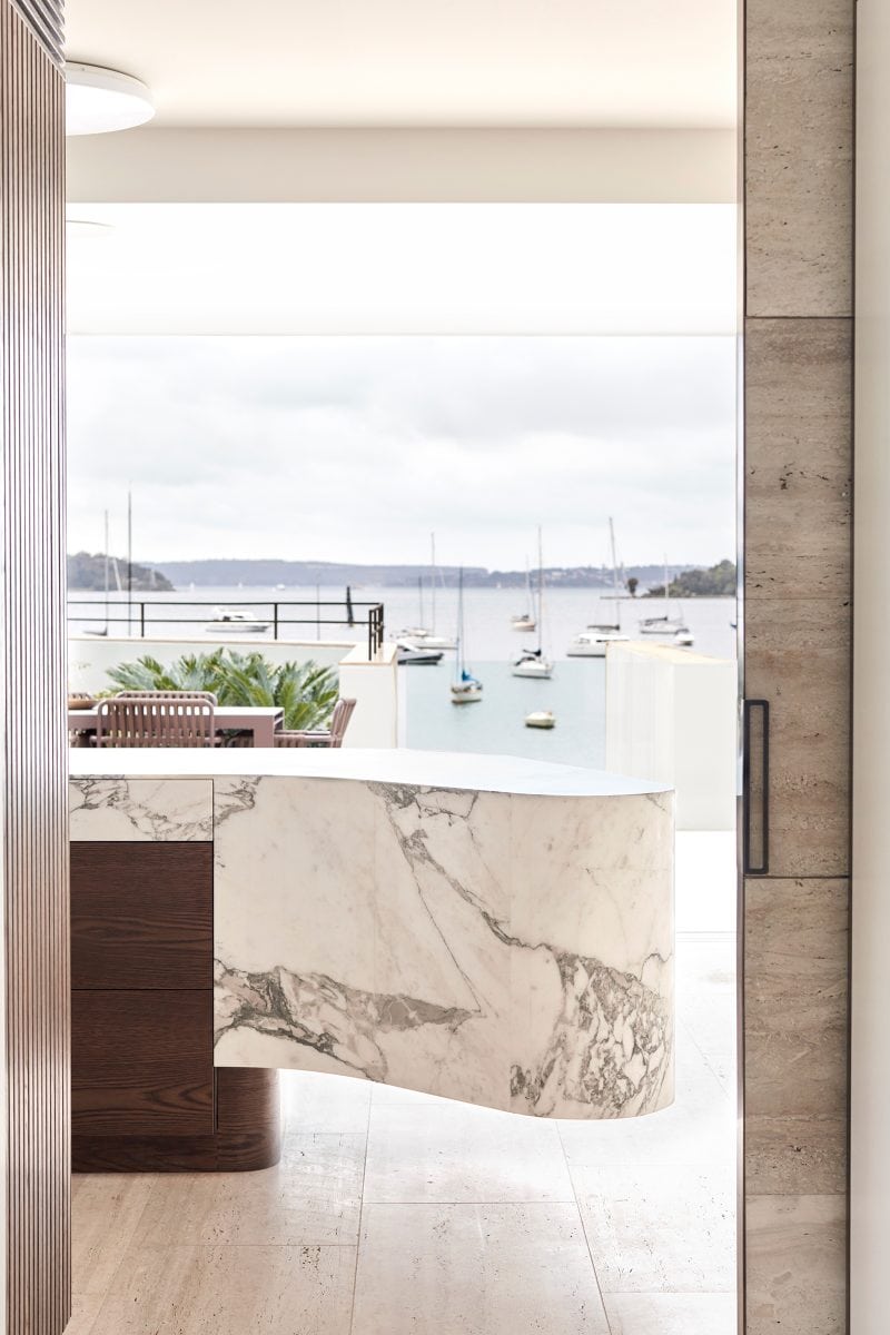 Luigi Rosselli's Upper Deck Calacatta Vagli marble and timber kitchen island with a waterfront view of the Sydney harbor