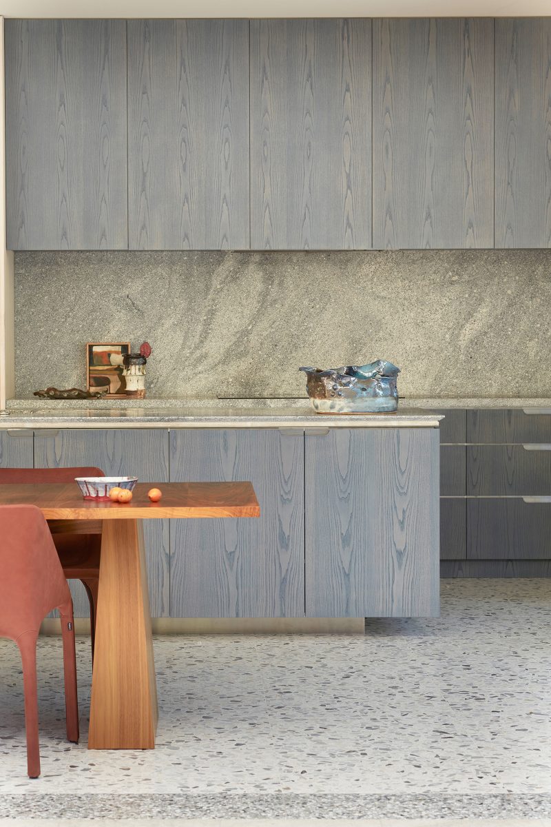 lime stain finish creates an ash grey timber veneer for the kitchen island and kitchen joinery façade, granite medulla bench top and backsplash